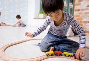 child playing with trains